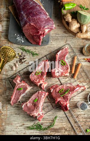 Raw lamb meat pieces on wooden surface, top view. Stock Photo