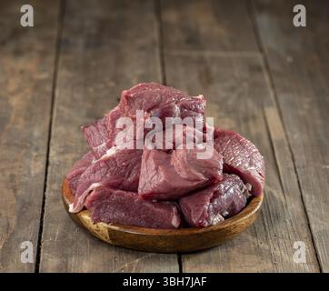 Sliced veal meat on wooden surface. Stock Photo