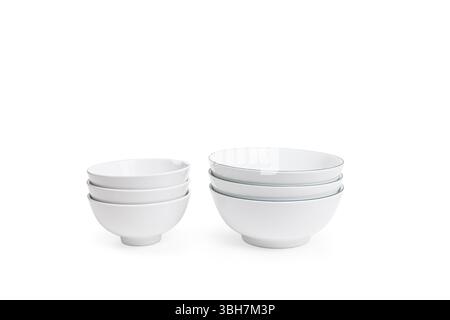 Small white ceramic bowls, neatly stacked isolated on white background. Emphasizing simplicity and elegance in design. Stock Photo