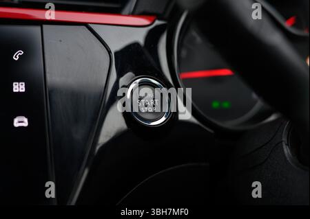 A car's dashboard with a start button and a stop button. The buttons are black and red Stock Photo