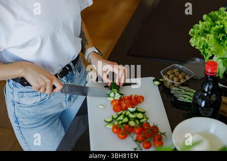 Healthy Cooking Skillfully Slicing Fresh, Colorful Vegetables in the Modern Kitchen Stock Photo