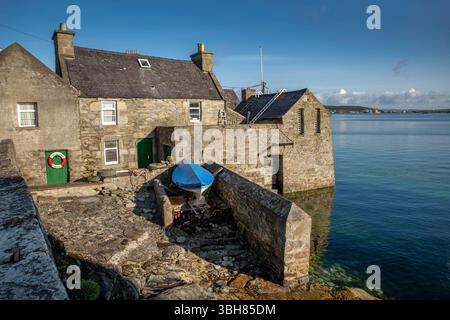 Da Lodberries in Lerwick glow in the summer morning sun – historic waterfront homes on Shetland’s shoreline. Stock Photo