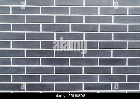 Black brick wall with uniform rectangular pattern. Stock Photo