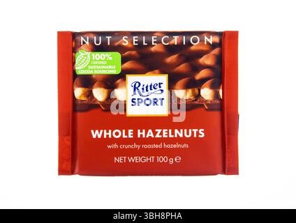LONDON, UK - NOVEMBER 24, 2024: Chocolate bar by Ritter Sport with whole hazelnuts on white. Stock Photo