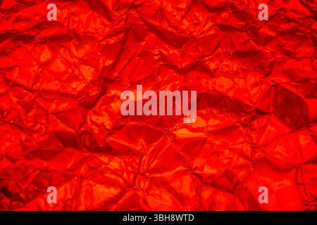 Bright Red background with heavy wrinkles. Recycled Bright Red kraft  paper texture as background. Stock Photo