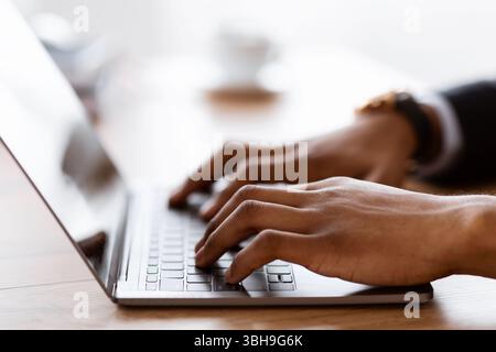 Male hands typing on laptop keyboard, cropped Stock Photo