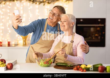 Elderly Couple Making Selfie Having Fun Celebrating Christmas At Home Stock Photo