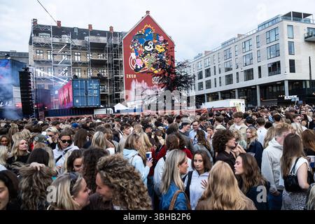 People gather at Den Rode Plads during Copenhagen Distortion 2025 in ...