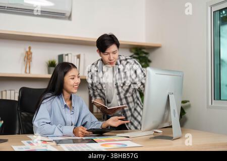 UX and UI Design Discussion. Young designers collaborating on digital project in modern office. Stock Photo