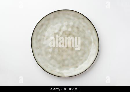 Empty textured plate on white background Stock Photo