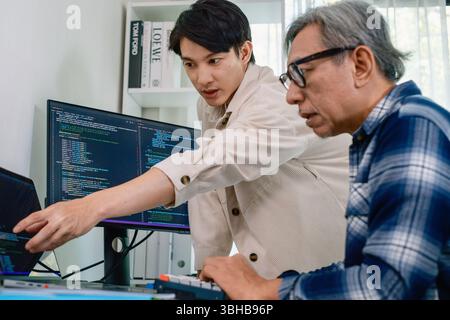 Group of asian senior in a collaborative software development analyzing  flowcharts  during a bootcamp training Stock Photo