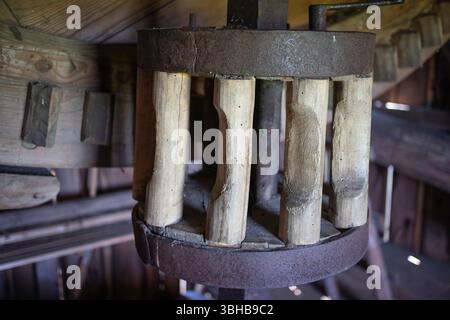 A wooden structure with a metal base and a wooden top. The structure is old and has a rustic appearance Stock Photo