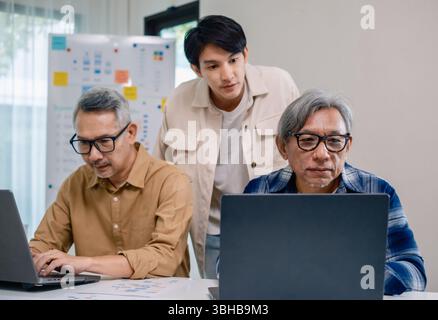 Asian Instructor Teaching Senior in Software Programming and Training Collaboration Stock Photo