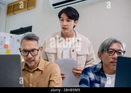 Asian Instructor Teaching Senior in Software Programming and Training Collaboration Stock Photo