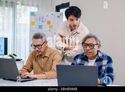 Asian Instructor Teaching Senior in Software Programming and Training Collaboration Stock Photo