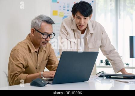 Asian Instructor Teaching Senior in Software Programming and Training Collaboration Stock Photo