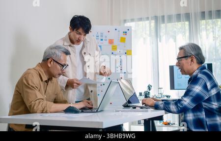 Asian Instructor Teaching Senior in Software Programming and Training Collaboration Stock Photo