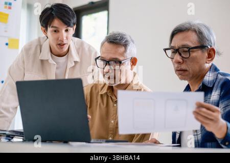 Asian Instructor Teaching Senior in Software Programming and Training Collaboration Stock Photo