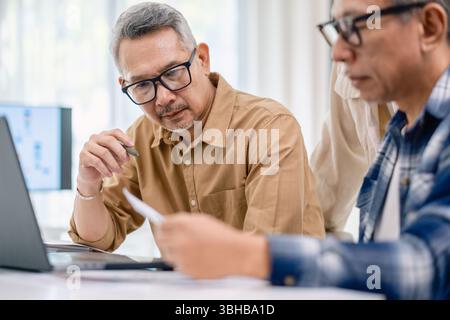 Asian Instructor Teaching Senior in Software Programming and Training Collaboration Stock Photo