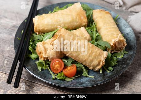 Crispy vegetables spring Rolls on wooden table Stock Photo