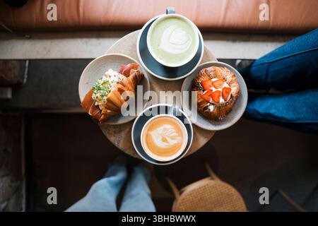 artisan food on a table with coffee and matcha in a cafe Stock Photo
