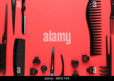Different hairdresser's tools on red background, flat lay. Space for text Stock Photo