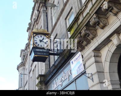 Vintage Clock Hanging on a Historic Stone Building in City Center. Aberdeen, Scotland Stock Photo