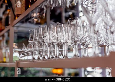 Romantically set dinner table with wine glasses and floral centerpiece, perfect for a wedding, elegant party, or outdoor evening celebration. Warm lig Stock Photo