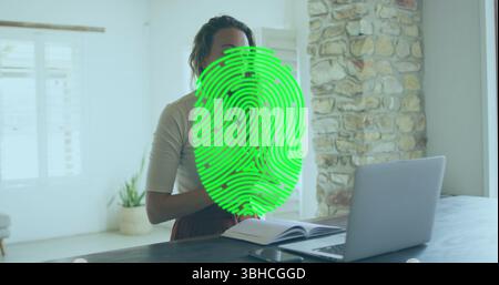 Image of biometric fingerprint scanner over caucasian having a imagecall on laptop at home. Cyber security and business technology concept Stock Photo