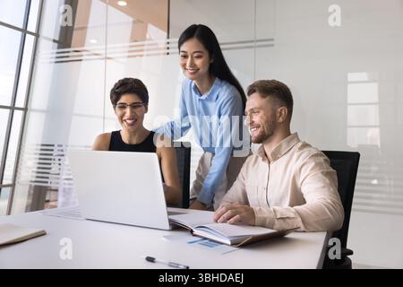 Employees learning new business AI tools or software using laptop Stock Photo