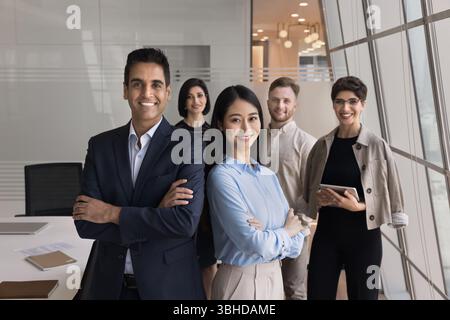 Team led by two executive managers posing in office Stock Photo