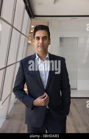 Vertical office portrait of mature Indian company boss Stock Photo