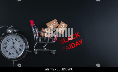 Discount events, Alarm clock and shopping cart with BLACK FRIDAY text, symbolizing time-sensitive sales, holiday shopping urgency and ecommerce promot Stock Photo