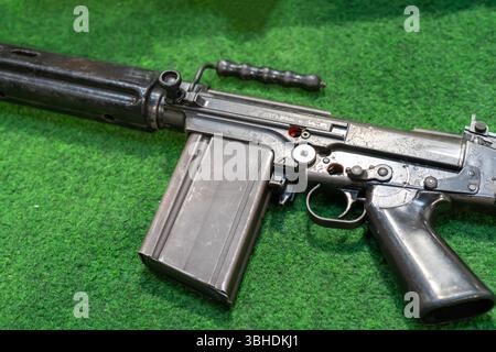 Vintage FN FALl battle rifle on green surface Stock Photo