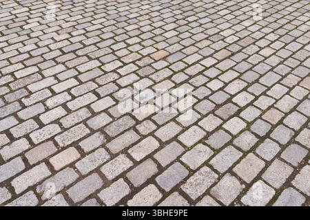 Vintage grey tumbled paving blocks in a UK street. Full frame background, texture or pattern Stock Photo