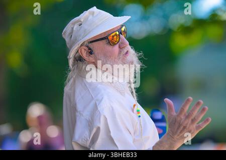 Man with beard braid dancing at street festival Stock Photo