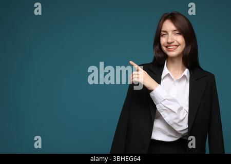 Happy woman in suit on light blue background, space for text Stock Photo