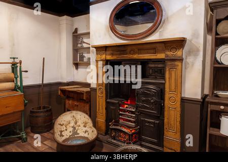 A charming vintage interior featuring a classic fireplace with a wooden mantel, antique mirror, and warm, nostalgic décor. Stock Photo