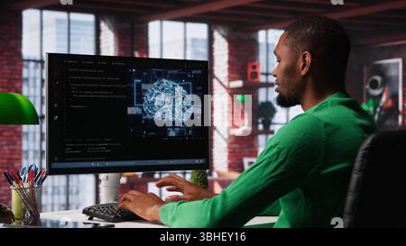 System administrator programming AI brain computerized model of neural network for machine learning, solving tasks on computer. Debugging software algorithm and checking for errors. Camera A. Stock Photo