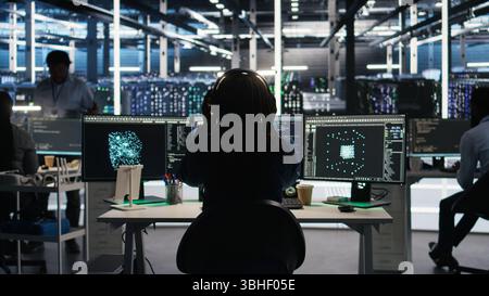 Data center engineer using algorithms to analyze large datasets, putting on headphones. Server farm IT professional using artificial intelligence to recognize data patterns listening music, camera A Stock Photo