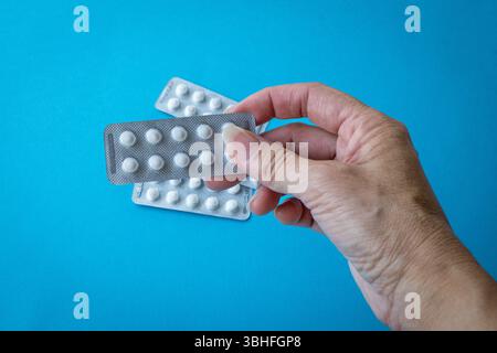 Woman holding medicine pills, close up view. Stock Photo