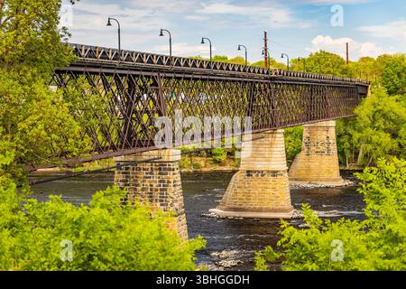 Golden sunset view of the River Lights Bridge at Phoenix Park in Eau Claire Wisconsin Stock Photo