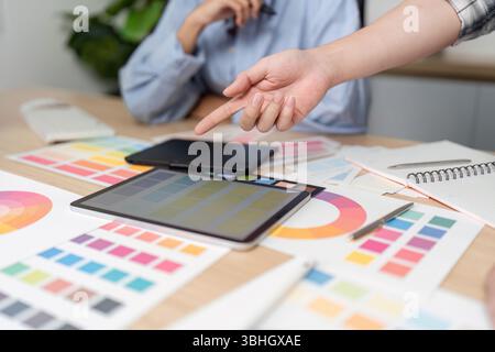 UX and UI Design Collaboration. Creative team discussing color palettes and design elements. Stock Photo