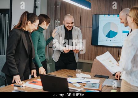 Team members collaborating in a modern office, discussing business strategies Stock Photo