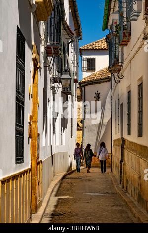 Cordoba back street with three friends walking Stock Photo