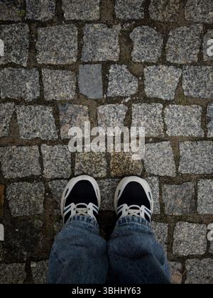 Close up of cobblestone street. Old road paved with granite stones Stock Photo