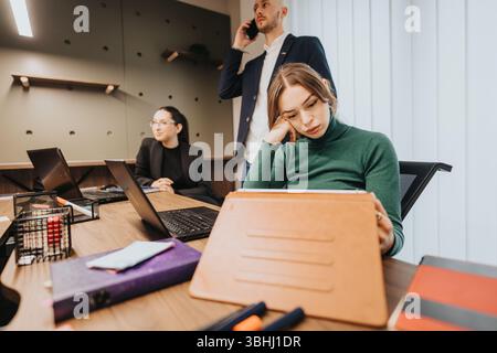 Office Team Engaged in Business Meeting and Collaboration Activities Stock Photo