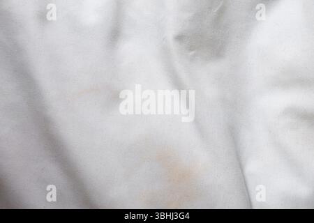 White background with spots with shadows and folds of fabric for design and backing, dirty white fabric, stains Stock Photo