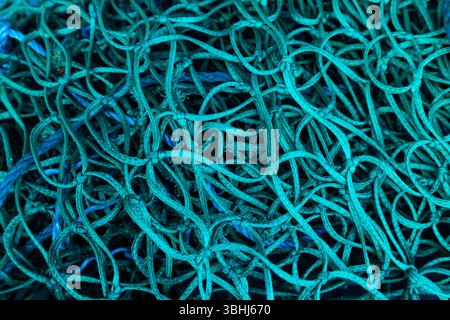 Background from a fabric grid of green color with large cells. Stock Photo