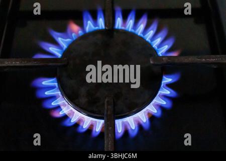 Flames from a lighted gas ring on a domestic range cooker, London, UK Stock Photo